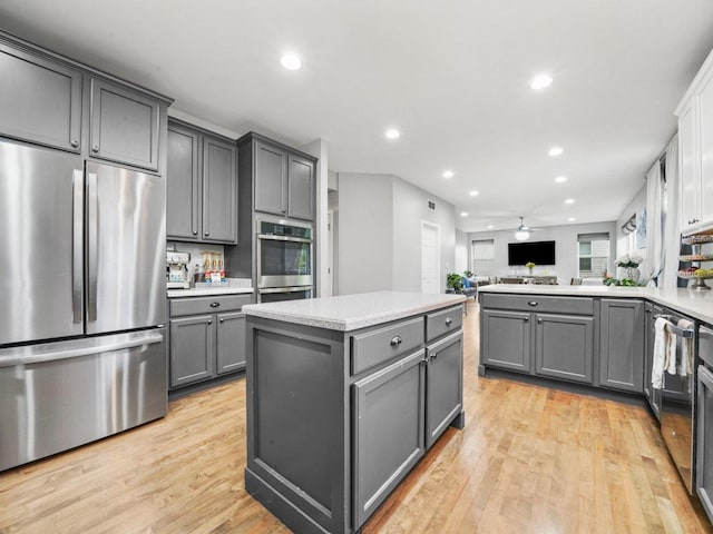 210 Woodford Rd, Oswego, IL 60543 - kitchen with stainless steel appliances, gray cabinetry, light wood-style floors, and recessed lighting