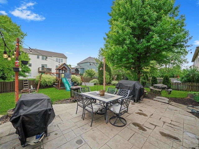 210 Woodford Rd, Oswego, IL 60543 - fenced backyard with a grill, a playground, a patio area, and outdoor dining area
