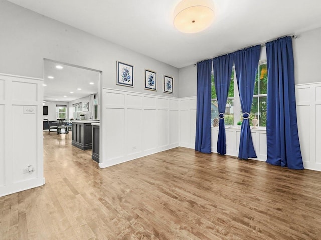 210 Woodford Rd, Oswego, IL 60543 - empty room featuring a decorative wall, light wood-type flooring, wainscoting, and recessed lighting