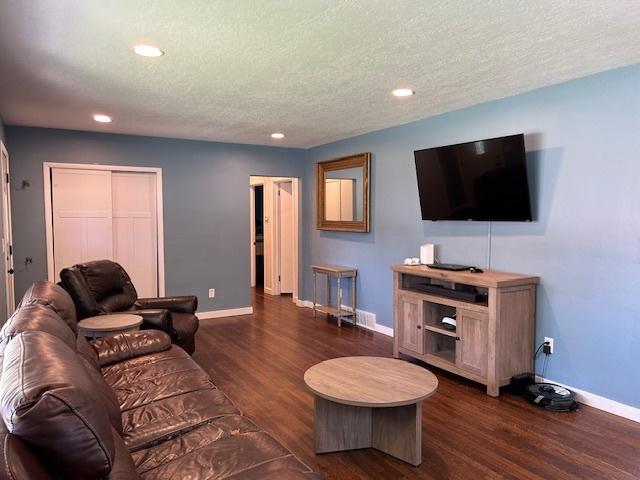 110 Shady Ln, Dixon, IL 61021 - living area featuring recessed lighting, dark wood-type flooring, and a textured ceiling