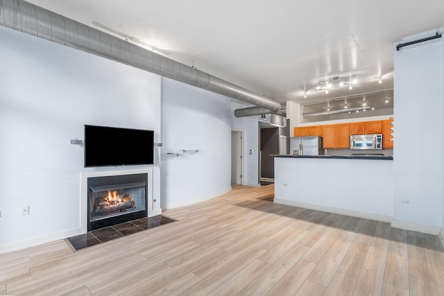1305 S Michigan Ave Unit 807, Chicago, IL 60605 - unfurnished living room featuring track lighting, light wood-style floors, and a fireplace with flush hearth