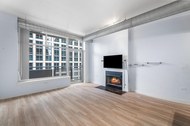 1305 S Michigan Ave Unit 807, Chicago, IL 60605 - unfurnished living room featuring wood finished floors and a fireplace with flush hearth