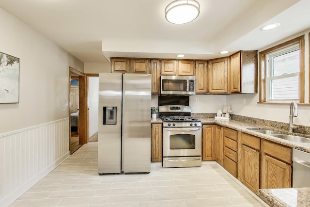 5836 N Oconto Ave, Chicago, IL 60631 - kitchen featuring stainless steel appliances, recessed lighting, brown cabinetry, and light stone counters