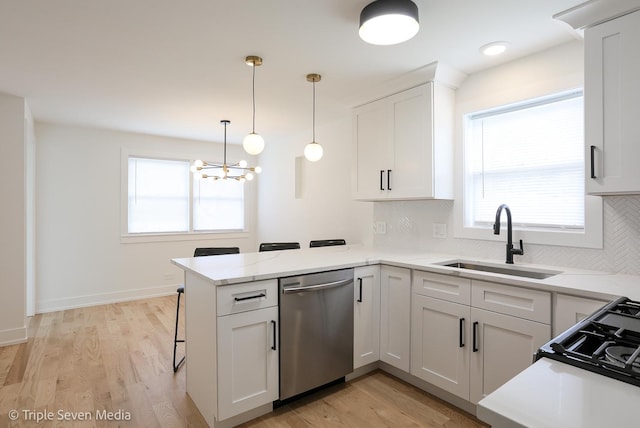 7939 Neva Ave, Burbank, IL 60459 - kitchen featuring stainless steel dishwasher, a peninsula, tasteful backsplash, and white cabinets