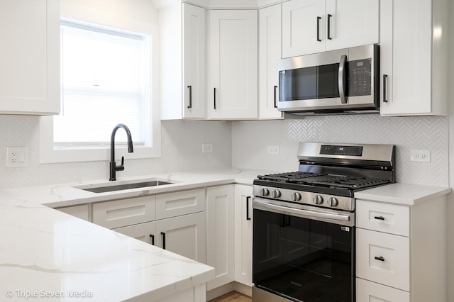 7939 Neva Ave, Burbank, IL 60459 - kitchen featuring stainless steel appliances, white cabinetry, light stone countertops, and decorative backsplash