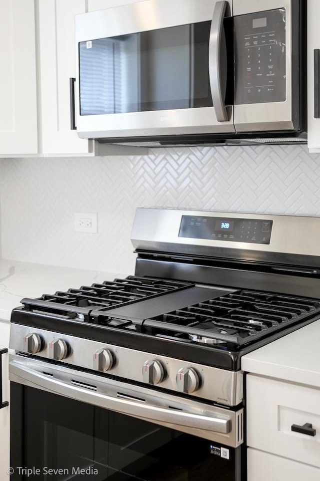 7939 Neva Ave, Burbank, IL 60459 - kitchen view of stainless steel appliances, backsplash, and white cabinets