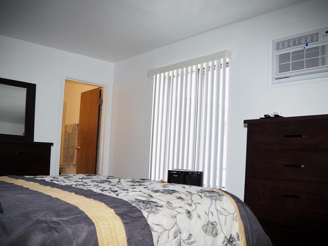 bedroom with a wall unit AC