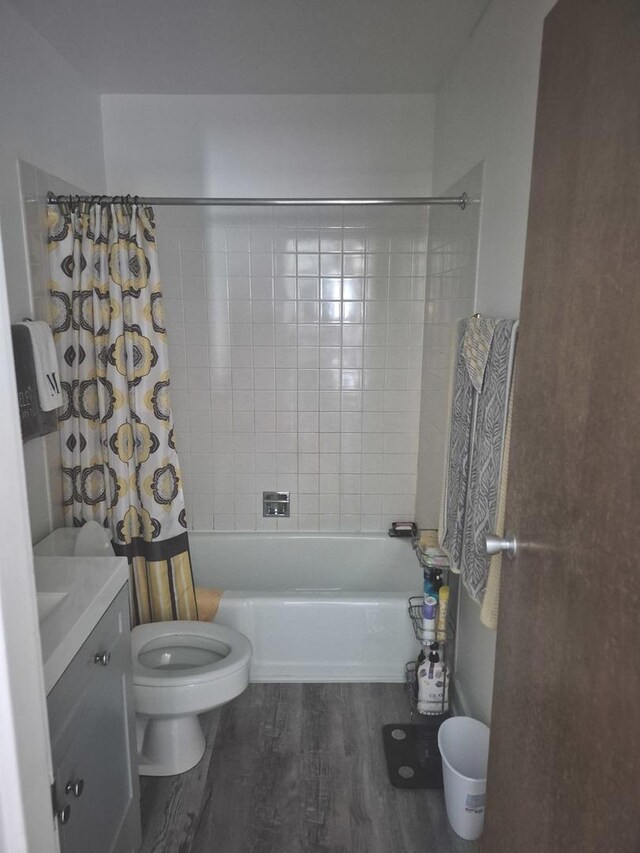 bathroom with shower / bath combo, wood finished floors, and vanity