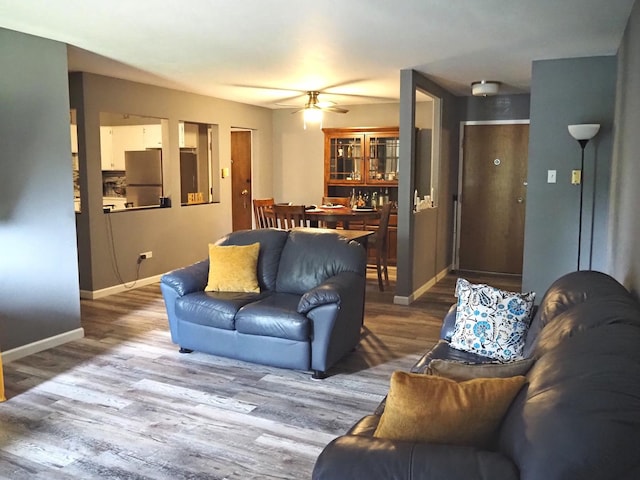 living room with ceiling fan and wood finished floors