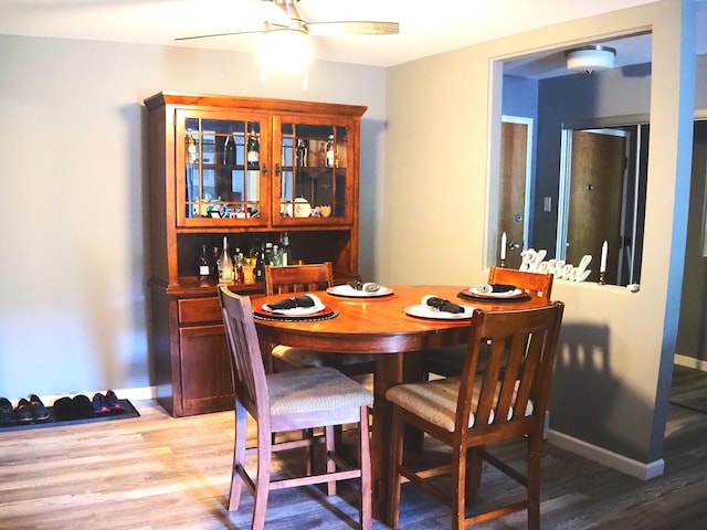 dining room with light wood-style flooring and ceiling fan