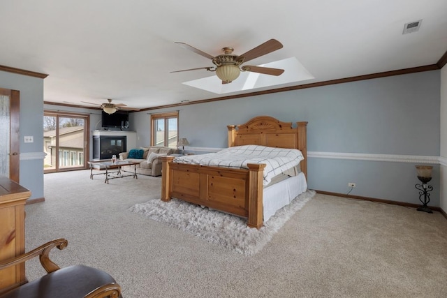 41W072 Bowes Rd, Elgin, IL 60124 - carpeted bedroom featuring crown molding, ceiling fan, a skylight, and a glass covered fireplace