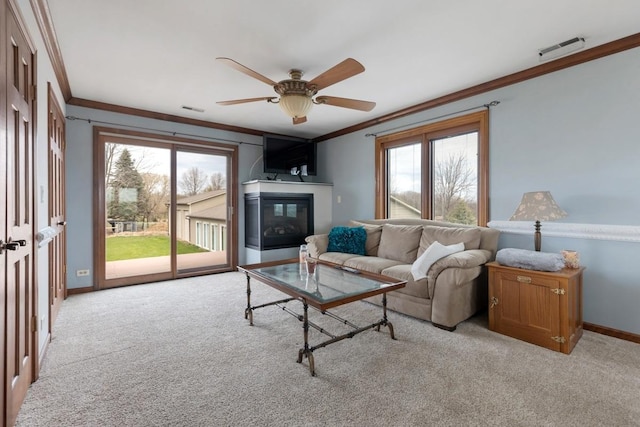 41W072 Bowes Rd, Elgin, IL 60124 - carpeted living room with crown molding, a glass covered fireplace, and a ceiling fan