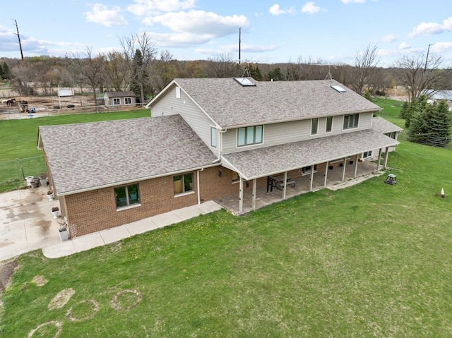 41W072 Bowes Rd, Elgin, IL 60124 - rear view of property with a shingled roof, a yard, a patio area, and brick siding