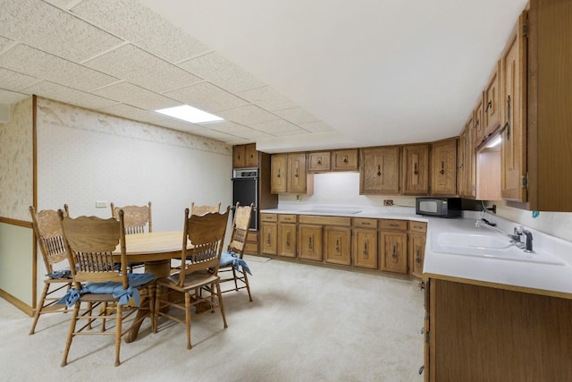 41W072 Bowes Rd, Elgin, IL 60124 - kitchen featuring brown cabinets, black microwave, light countertops, light carpet, and electric cooktop