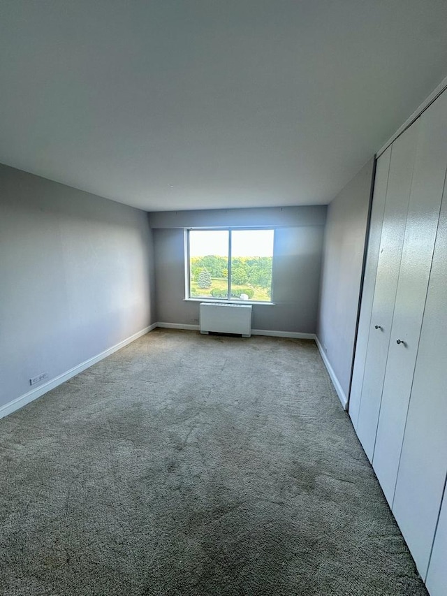 7033 N Kedzie Ave Unit 701, Chicago, IL 60645 - unfurnished bedroom featuring carpet floors, a closet, and radiator
