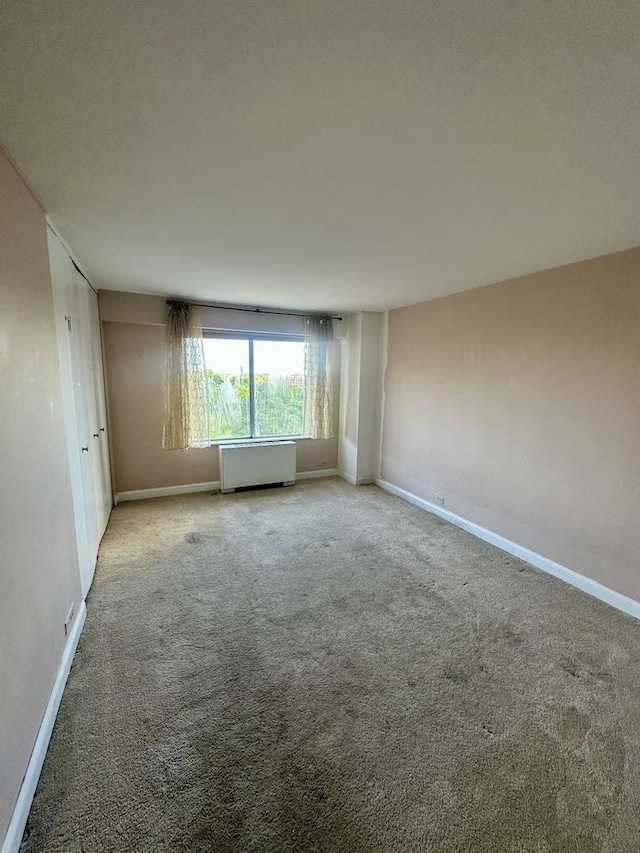 7033 N Kedzie Ave Unit 701, Chicago, IL 60645 - unfurnished room with radiator and carpet flooring