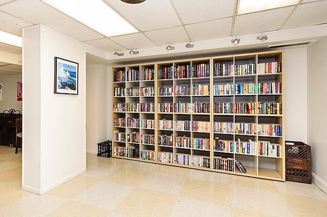 7033 N Kedzie Ave Unit 701, Chicago, IL 60645 - sitting room with a paneled ceiling, wall of books, and tile patterned floors