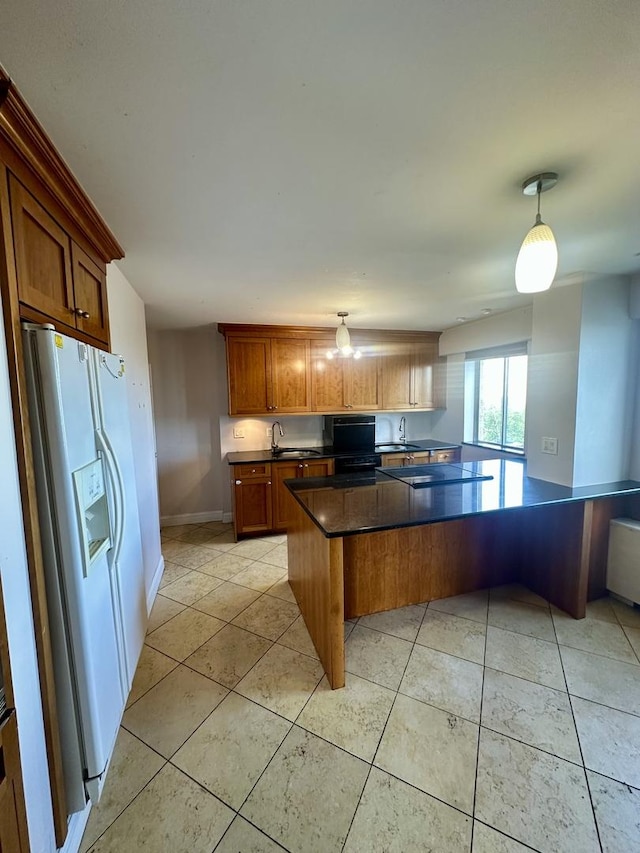 7033 N Kedzie Ave Unit 701, Chicago, IL 60645 - kitchen with white fridge with ice dispenser, dark countertops, light tile patterned floors, and brown cabinets