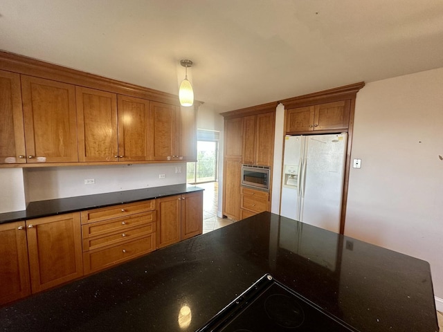 7033 N Kedzie Ave Unit 701, Chicago, IL 60645 - kitchen with white refrigerator with ice dispenser, stainless steel microwave, brown cabinetry, dark stone counters, and decorative light fixtures