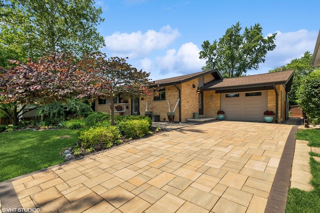 316 S Reuter Dr, Arlington Heights, IL 60005 - view of front facade featuring an attached garage, brick siding, a front yard, and driveway