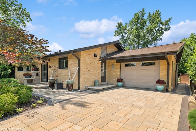 316 S Reuter Dr, Arlington Heights, IL 60005 - view of front facade with a garage, brick siding, and decorative driveway