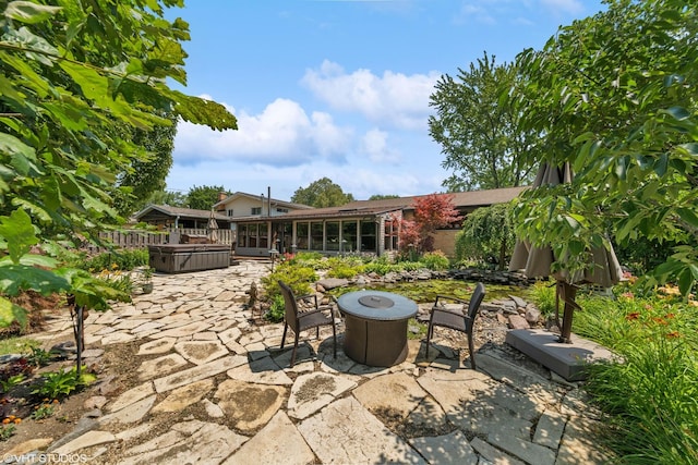 316 S Reuter Dr, Arlington Heights, IL 60005 - view of patio featuring a hot tub, an outdoor fire pit, and a sunroom