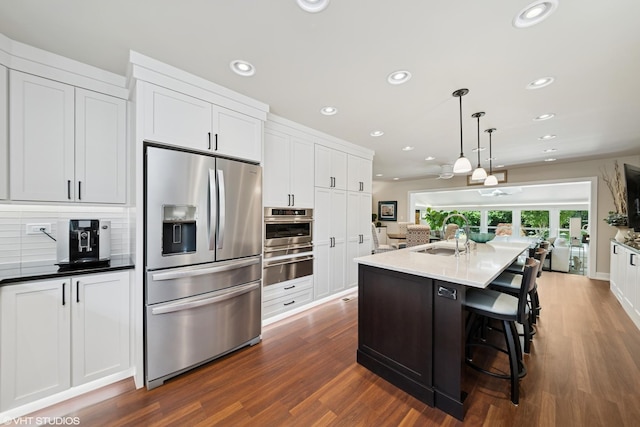 316 S Reuter Dr, Arlington Heights, IL 60005 - kitchen featuring stainless steel appliances, dark wood-style floors, a warming drawer, recessed lighting, and white cabinets