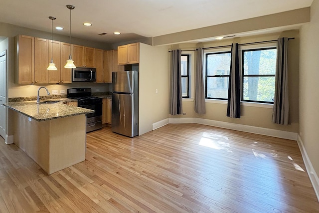 76351/2 N Greenview Ave Unit 1S, Chicago, IL 60626 - kitchen featuring stainless steel appliances, light stone counters, light wood-type flooring, recessed lighting, and a peninsula