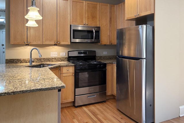 76351/2 N Greenview Ave Unit 1S, Chicago, IL 60626 - kitchen featuring stainless steel appliances, light wood-style floors, stone counters, and hanging light fixtures
