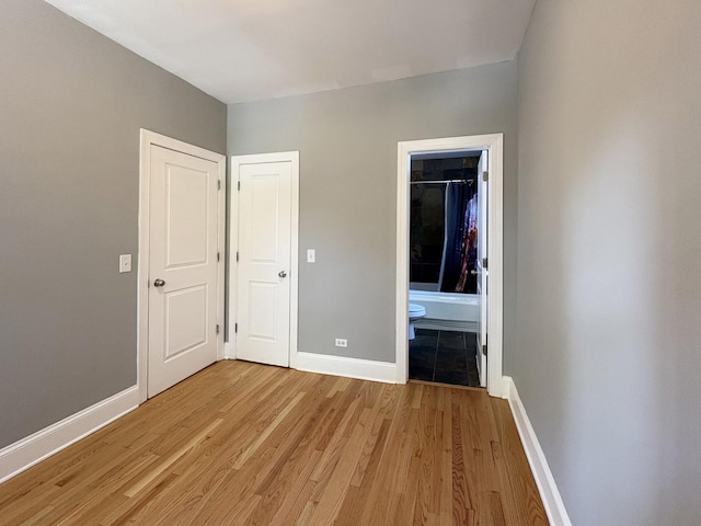 76351/2 N Greenview Ave Unit 1S, Chicago, IL 60626 - unfurnished bedroom with light wood-style floors and ensuite bath