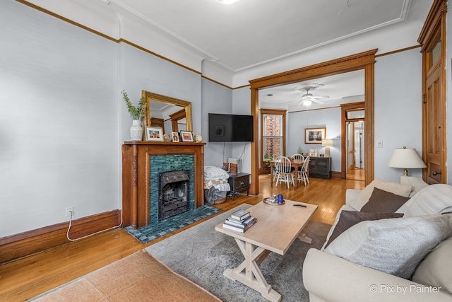 3516 N Reta Ave, Chicago, IL 60657 - living room featuring crown molding, wood finished floors, a fireplace with flush hearth, and a ceiling fan