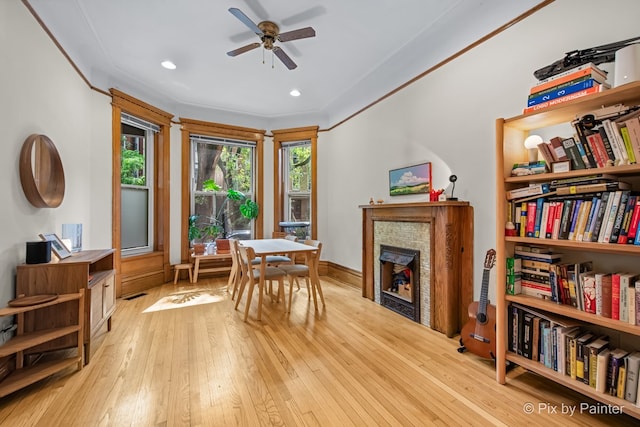 3516 N Reta Ave, Chicago, IL 60657 - dining area featuring ceiling fan, a fireplace, light wood-type flooring, recessed lighting, and crown molding