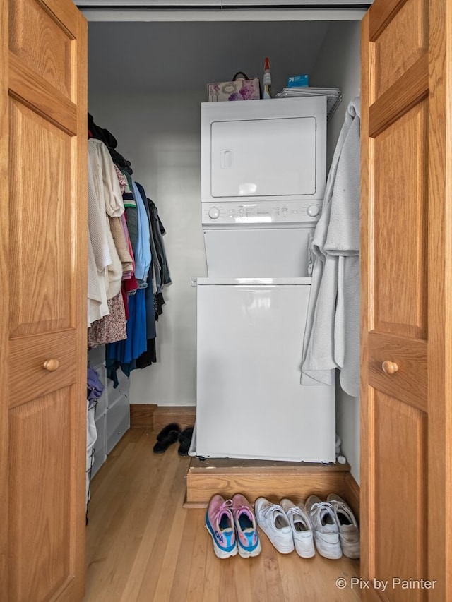 3516 N Reta Ave, Chicago, IL 60657 - washroom featuring stacked washing machine and dryer and wood finished floors