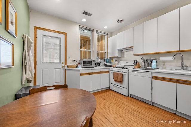 3516 N Reta Ave, Chicago, IL 60657 - kitchen with white appliances, white cabinetry, light countertops, light wood-style flooring, and recessed lighting
