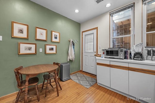 3516 N Reta Ave, Chicago, IL 60657 - kitchen with white cabinets, light countertops, light wood finished floors, and recessed lighting