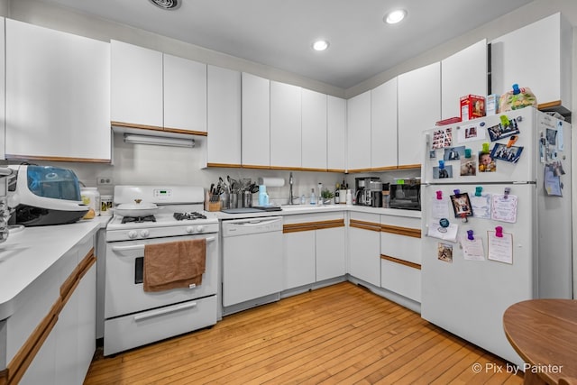 3516 N Reta Ave, Chicago, IL 60657 - kitchen featuring white appliances, light countertops, light wood-type flooring, recessed lighting, and white cabinetry