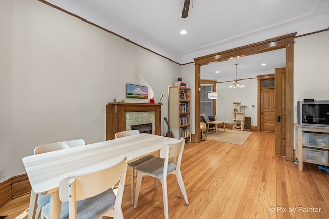 3516 N Reta Ave, Chicago, IL 60657 - dining room featuring a fireplace, crown molding, light wood-type flooring, recessed lighting, and a chandelier