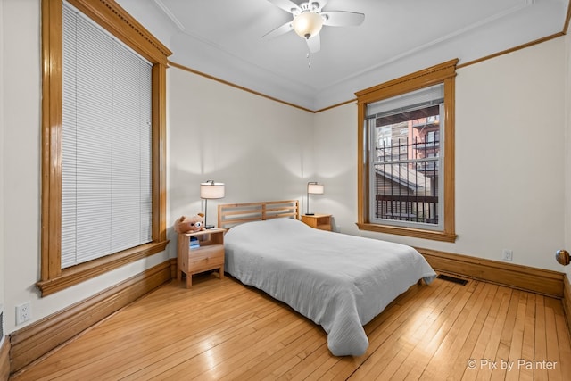 3516 N Reta Ave, Chicago, IL 60657 - bedroom with wood-type flooring, crown molding, and a ceiling fan
