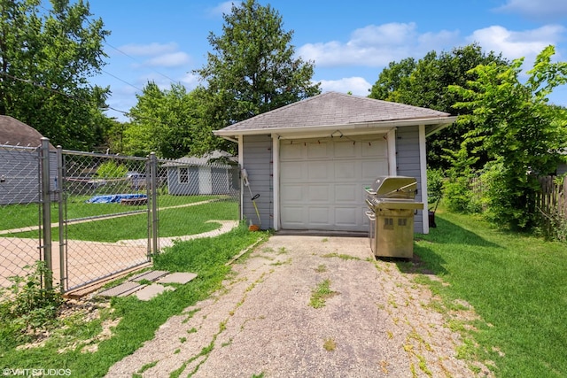 609 N 7th St, Dekalb, IL 60115 - detached garage with asphalt driveway and a gate