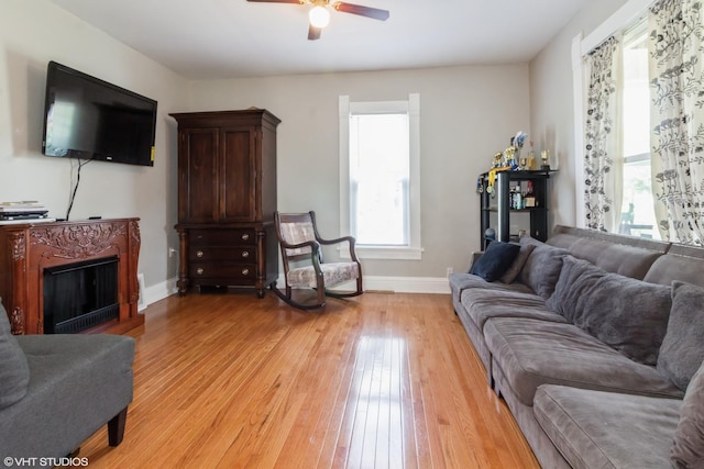609 N 7th St, Dekalb, IL 60115 - living room with light wood-type flooring, ceiling fan, and a fireplace