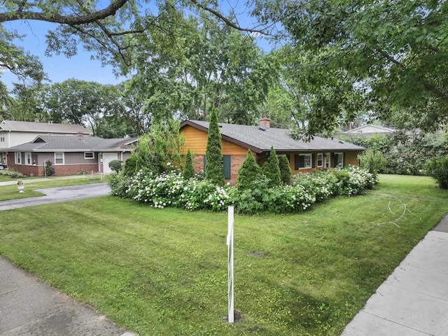 1207 W Busse Ave, Mount Prospect, IL 60056 - view of front of home featuring a chimney, a front lawn, concrete driveway, and brick siding
