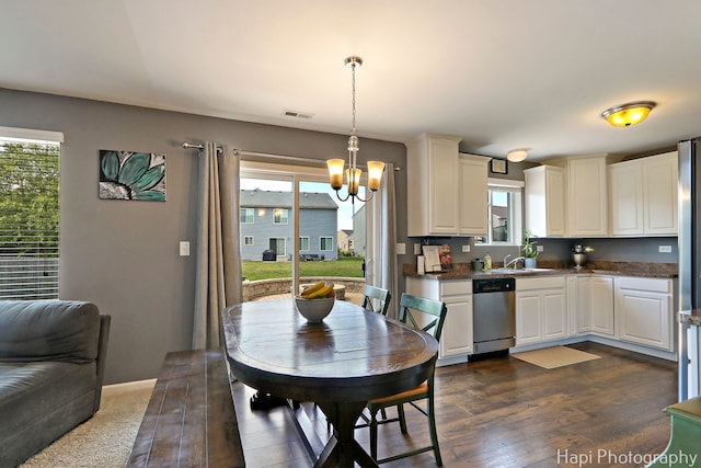 218 Minuet Cir, Volo, IL 60073 - kitchen with dishwasher, a chandelier, dark countertops, dark wood finished floors, and pendant lighting