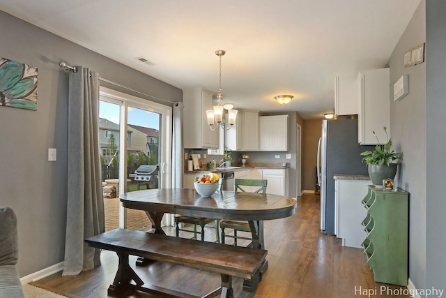 218 Minuet Cir, Volo, IL 60073 - dining space with dark wood-style flooring and a chandelier