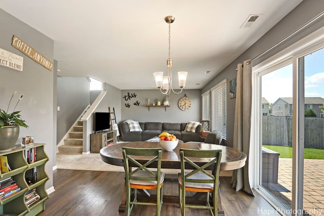 218 Minuet Cir, Volo, IL 60073 - dining area with dark wood-style floors, healthy amount of natural light, a chandelier, and stairs