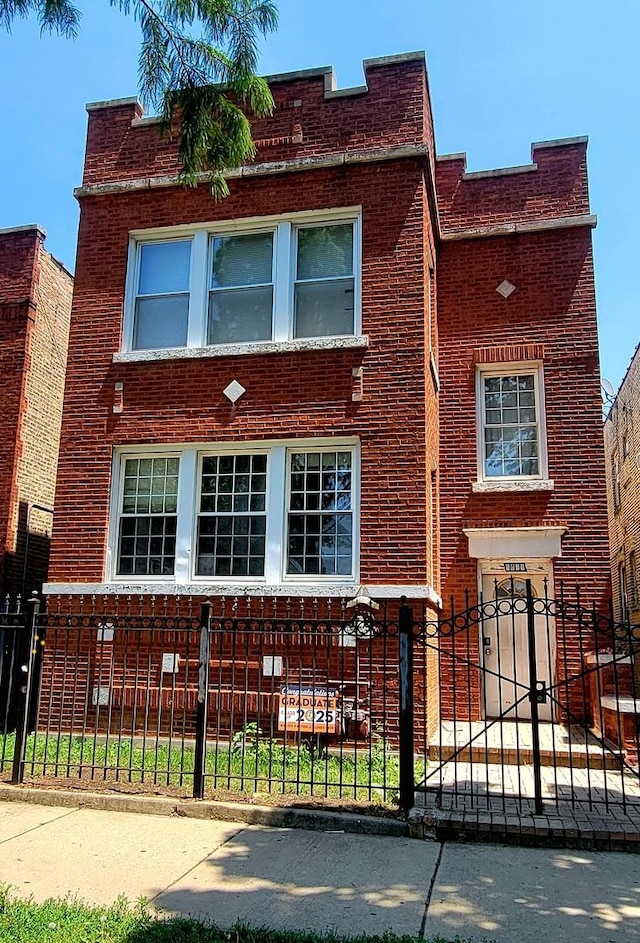 6011 S Troy St, Chicago, IL 60629 - view of front facade featuring a fenced front yard and brick siding