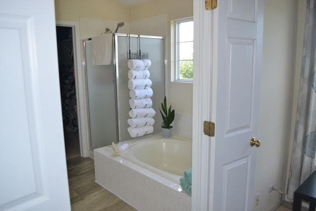 4355 Barharbor Dr, Lake In The Hills, IL 60156 - bathroom featuring a stall shower, a garden tub, wood finished floors, and a closet