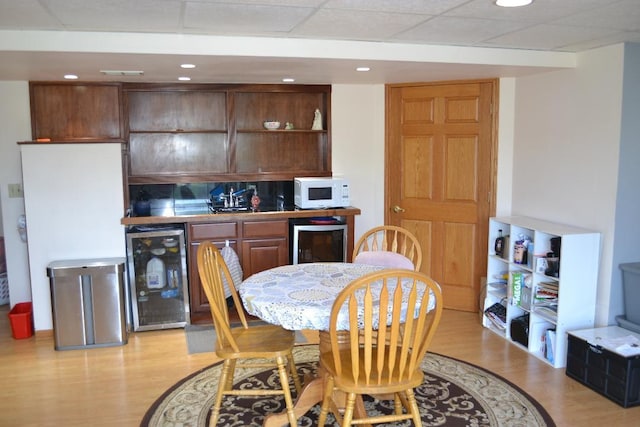4355 Barharbor Dr, Lake In The Hills, IL 60156 - kitchen with wine cooler, light wood finished floors, white microwave, recessed lighting, and a drop ceiling