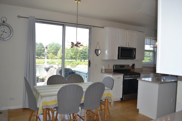 4355 Barharbor Dr, Lake In The Hills, IL 60156 - kitchen with stainless steel range oven, white cabinetry, light wood-style flooring, and light countertops