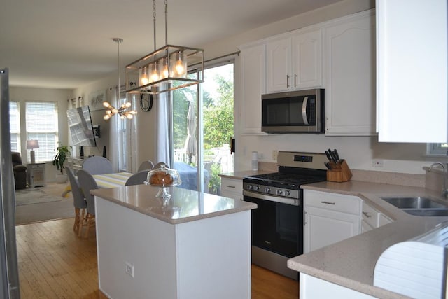 4355 Barharbor Dr, Lake In The Hills, IL 60156 - kitchen featuring stainless steel appliances, white cabinets, a center island, and light wood-style floors