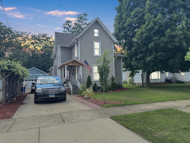 307 Christie St, Ottawa, IL 61350 - traditional-style home featuring an outbuilding, a yard, concrete driveway, and a shingled roof